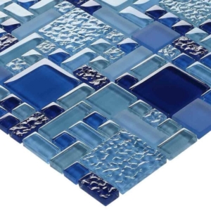 A close-up of a mosaic tile sheet featuring various shades of blue and textured glass tiles in different shapes and sizes, perfect for adding a touch of elegance to fiberglass pools or luxury pools.