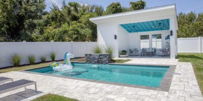 Family pool house with inflatable by Ashton Pools by Design