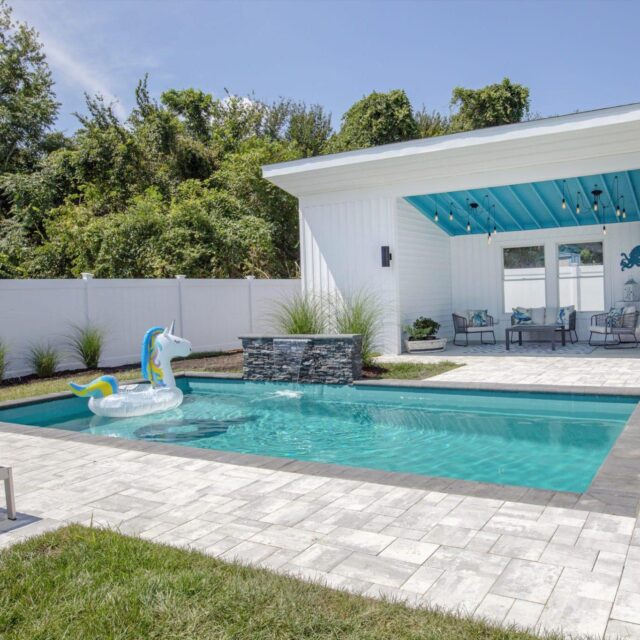 Family pool house with inflatable by Ashton Pools by Design