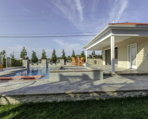 outdoor living area with pool by ashton pools by design