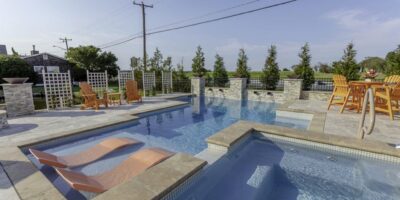 outdoor swimming pool with hot tub by ashton pools by design