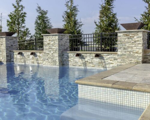 outdoor swimming pool with water features by ashton pools by design