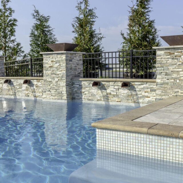 outdoor swimming pool with water features by ashton pools by design