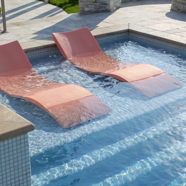 Sunloungers in Swimming Pool by Ashton Pools by Design