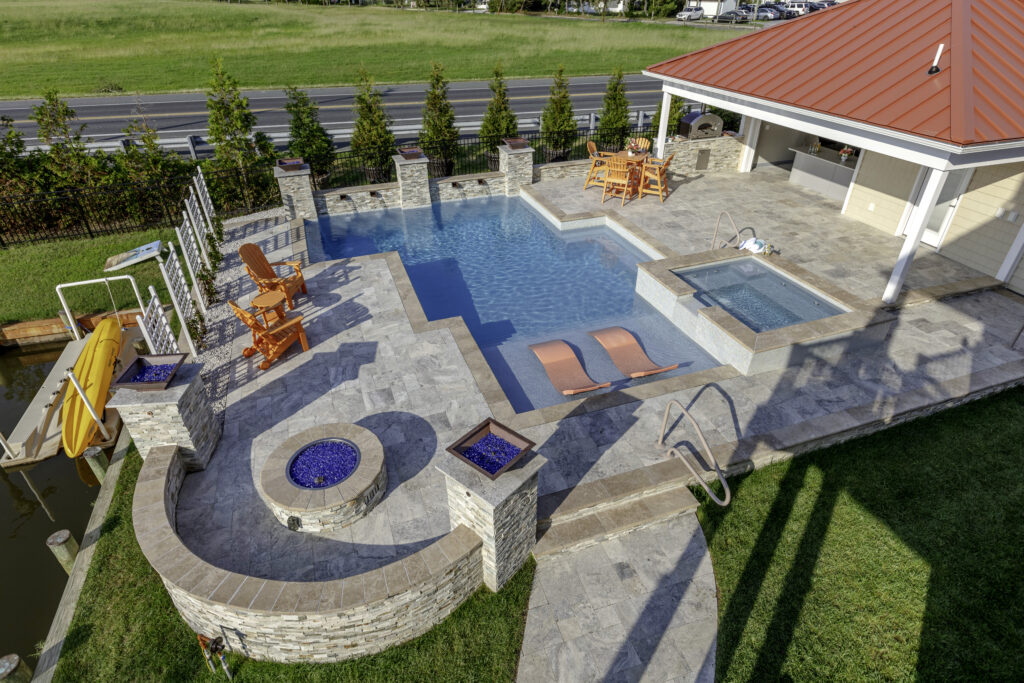 Geometric pool with firepit, spa, and pool house