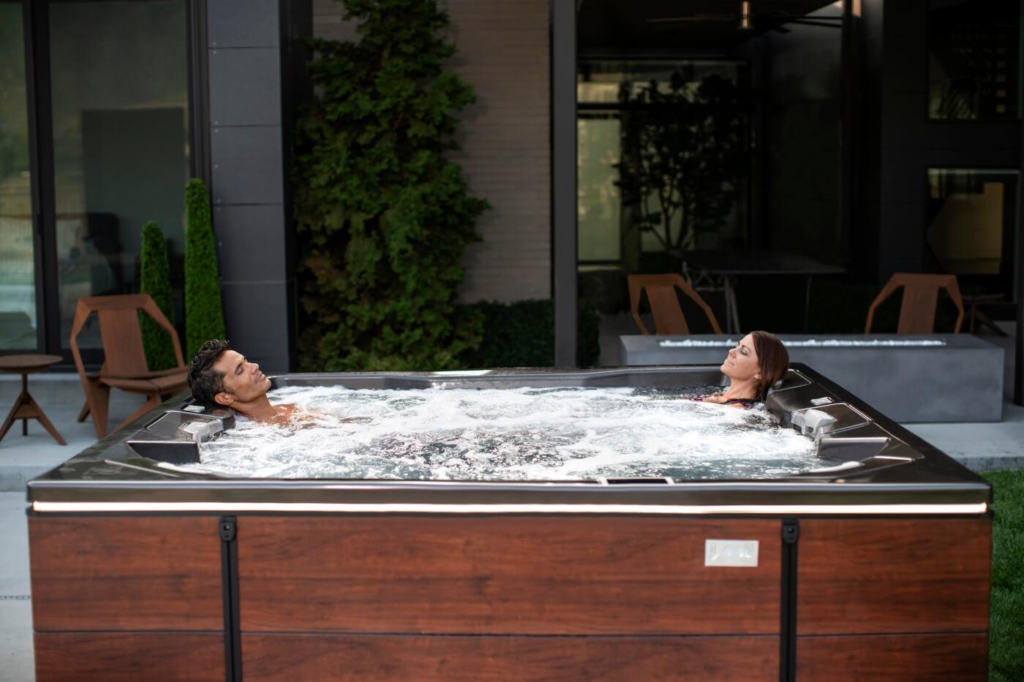 Couple enjoying a Bullfrog Spa from Ashton Pools By Design. 