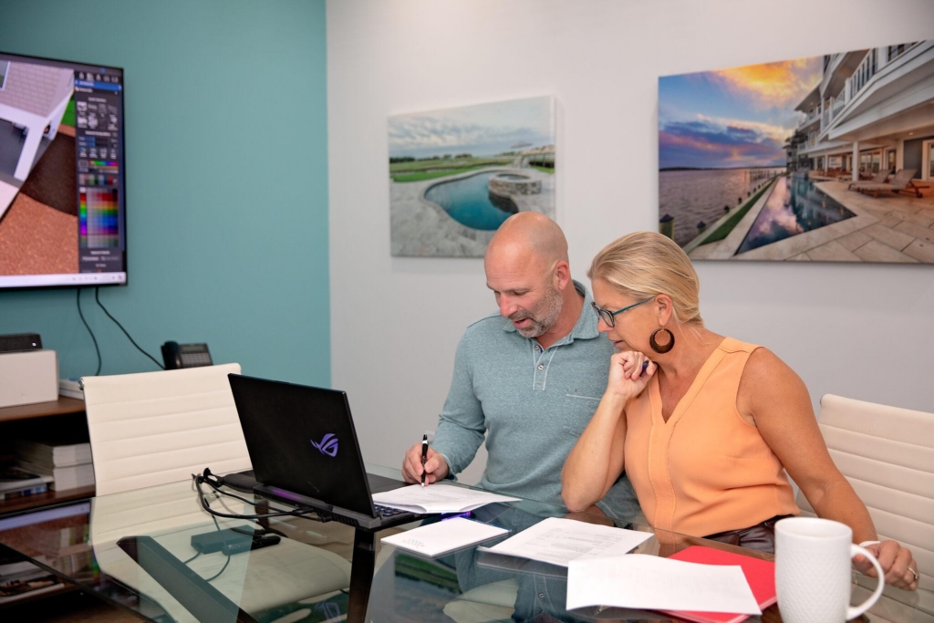 A couple going over their outdoor design contracts, and approval process