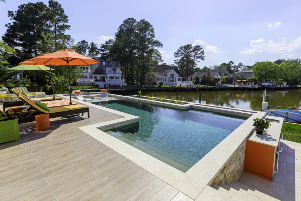Photograph of a Master Pools Guild winning pool with beautiful decking and furniture