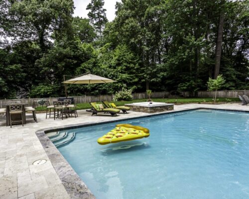 Concrete pool with beige travertine