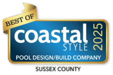 A blue and gold badge reads Best of Coastal Style 2025 Pool Design/Build Company, Sussex County—celebrating excellence in luxury pools and outdoor kitchens.