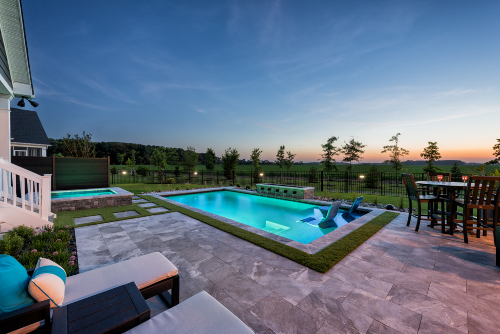 Modern backyard pool with pergola, water features, and outdoor living area | Ashton Pools by Design