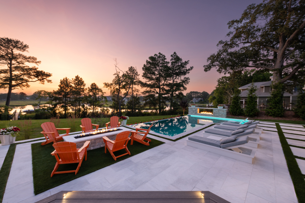 luxury outdoor space with custom gunite pool, fire pit with patio and fire pit on the edge of the pool as well