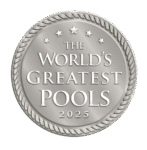 A silver medallion with rope edging displays the text The Worlds Greatest Pools 2025, surrounded by five stars—a true symbol of excellence for luxury pools and stunning outdoor kitchens.