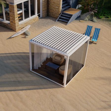 A modern white cabana with two chairs and a table sits on sandy ground near a house, perfect for outdoor living, with two blue-striped lounge chairs and a surfboard nearby.