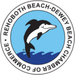Logo of the Rehoboth Beach-Dewey Beach Chamber of Commerce featuring a dolphin above ocean waves, surrounded by the organization’s name in a circular border—perfect for those who enjoy outdoor living by the shore.