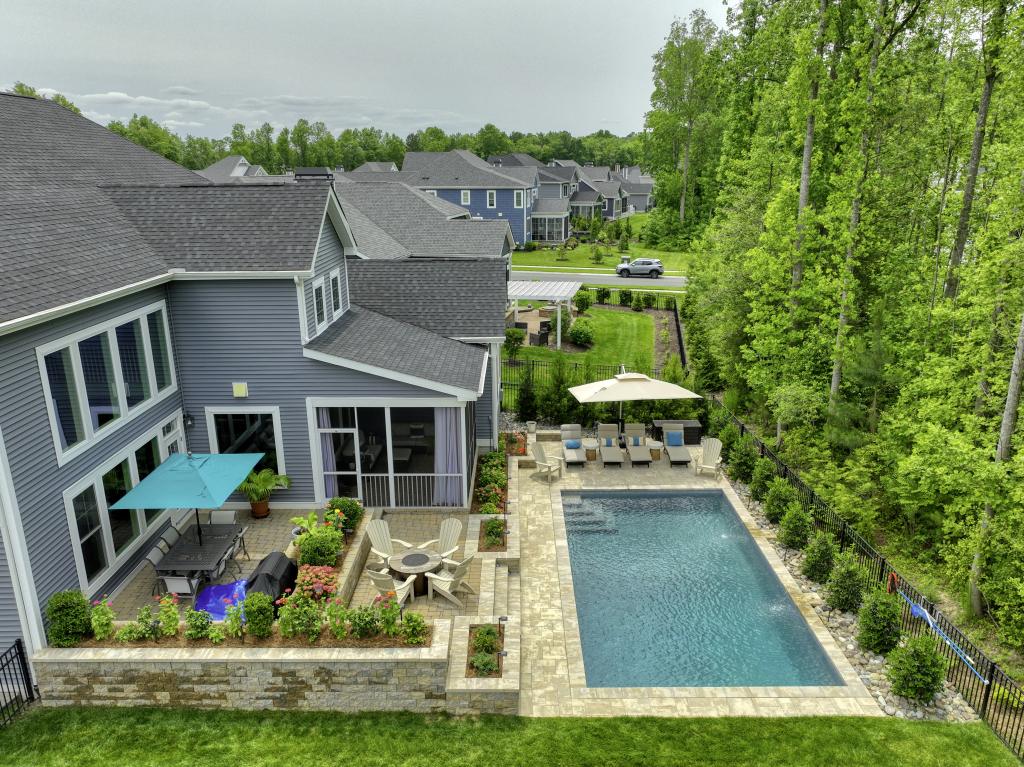 Photograph of a Schell brothers home with custom pool integrated seemlessly with the existing courtyard