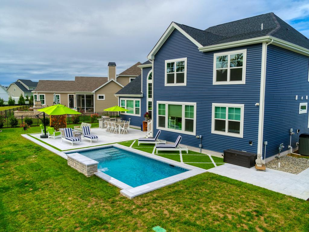 Integrated pool with a Schell Brothers home, turf inlay